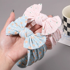 Nylon baby headband set with large floral bow ornaments and elastic ribbed texture