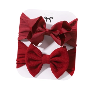 Set of two dark red baby headbands with ribbed bows and waffle texture nylon fabric