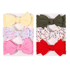 Set of 6 soft elastic nylon baby headbands with large bows in solid colors and floral prints