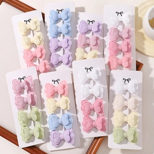 Close-up of colorful butterfly hair clip sets on white card display for girls