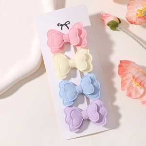 Set of four pastel butterfly hair clips in linen fabric displayed on white card