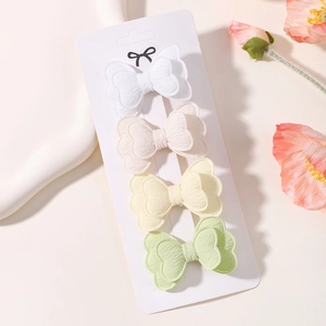 Detail of four-piece double-layer butterfly hair clips in pastel cotton fabric