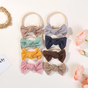 Set of 8 soft elastic nylon headbands with handmade ribbed fabric bows for babies