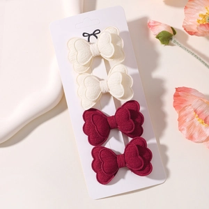 Detail of 4pcs double-layer butterfly clips in cream and burgundy on a display card