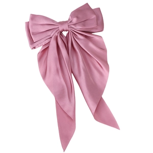 Elegant dusty pink oversized satin bow hair clip with long ribbons on white background