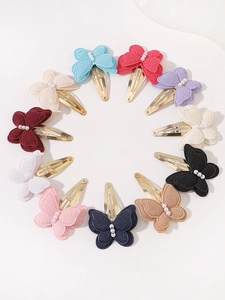 Detail of multi-color fabric butterfly hair clips with pearl beads and gold metal clips