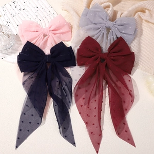 Detail of multi-color mesh hair clips with plumeti dot texture and long ribbons