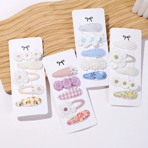 Detail of cute baby hair clip set featuring embroidered flowers and lace appliques