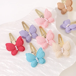 Set of double-layer embroidered butterfly hair clips with pearls on white display tray