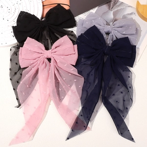 Detailed view of layered swiss dot chiffon bow hair clips with long elegant ribbons