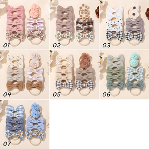 Detail view of colorful bow headband sets for infants with various fabric flower styles