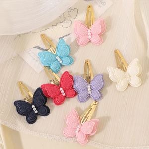 Close-up of handmade 3D butterfly hair clips with embroidery and pearls in six colors