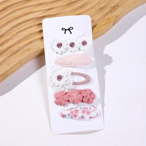 Detail view of 5-piece floral fabric hair clip set with daisy embroidery on display card