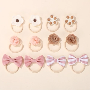 Detailed set of 12 children's hair ties with fabric bows, roses, and tulle floral designs