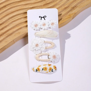 Detail view of 5-piece floral embroidery hair clip set for kids on display card
