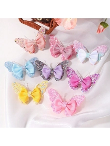 Close-up of eight colorful glitter butterfly hair clips with delicate beads and ribbons