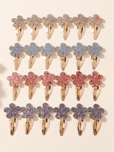 Dettaglio dei fermagli per capelli a fiore glitterati in oro, argento, rosso e viola