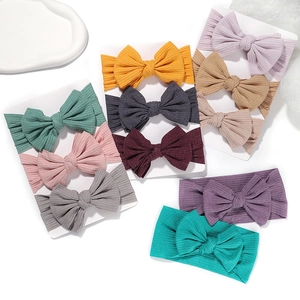 Detail of multi-color ribbed baby headbands with soft elastic bows in various vibrant shades