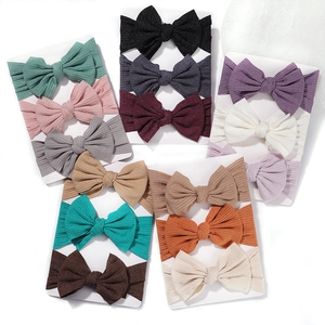 Set of soft ribbed baby headbands with large bows in assorted trendy colors on cards