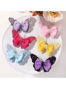 Detail view of colorful glitter butterfly hair clips set with ribbon bows for girls