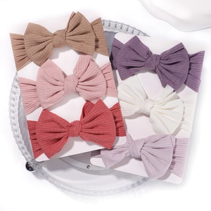 6-pack soft elastic baby headbands with large bows in varied colors on ribbed knit fabric