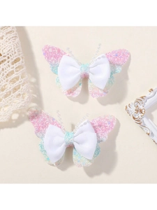 Close-up of glittery butterfly hair clips with pink and blue sequins and bead details