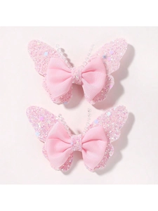 Detailed view of pink butterfly hair clips set with glitter wings and beaded antennae