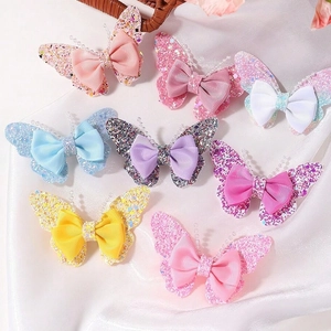 Set of 8 glitter butterfly hair clips with grosgrain bows on white silk background