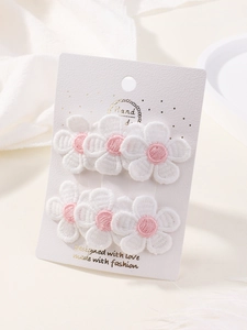 Detail view of 6-piece embroidered floral hair clips set on a premium white display card