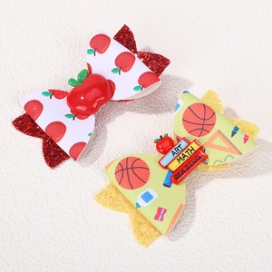 Sparkly glitter bow hair clips for girls featuring apple and school themed prints