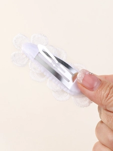 Detailed back view of white lace floral BB clip with secure silver metal hair pin