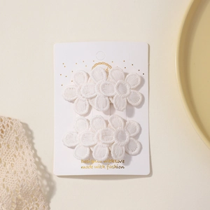 Pair of white lace flower hair clips with embroidery on display card for girls