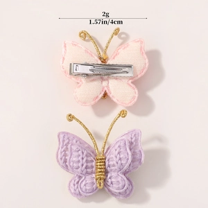 Handmade knitted butterfly hair clip set in soft pink and purple with gold wire details