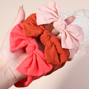 Three-piece baby nylon headbands with handmade bows in soft pink, orange and coral colors