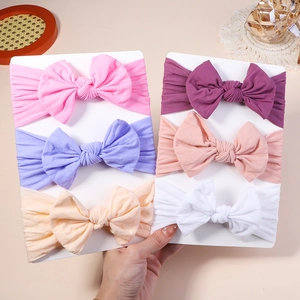 Detail showing 6-pack of soft nylon baby bow headbands in various pastel colors