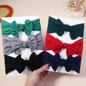 Close-up of 6-piece baby bow headband set in nylon showing soft textures and varied colors