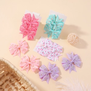 Détail de l'ensemble de barrettes à cheveux à nœuds en ruban fleuri pour bébés