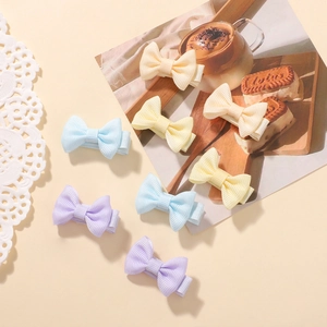 Detailed view of colorful grosgrain ribbon bow hair clips set for young girls