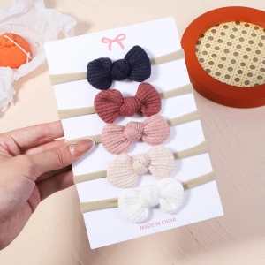 Set of 5 waffle knit baby headbands with soft bows in navy, pink, and neutral colors