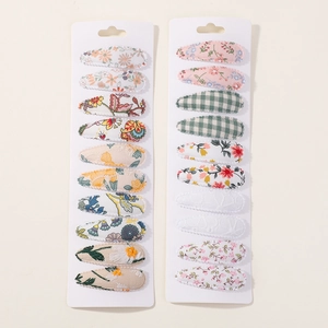 Detailed set of 20 fabric floral and plaid snap hair clips on white display cards
