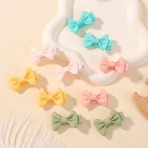 Close-up of 10-piece mini grosgrain ribbon bow clips in various pastel macaron colors