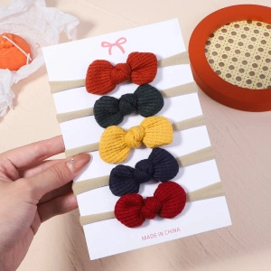 Set of five waffle knit bow headbands in various colors for babies and toddlers