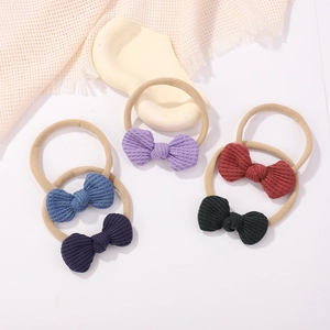 Five-pack of waffle fabric knotted bow headbands for infants in assorted solid colors