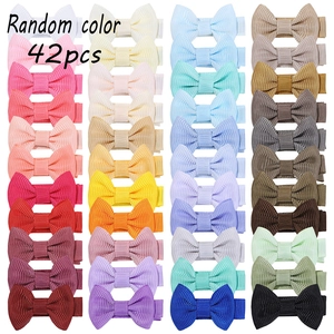 Flat lay of 42pcs grosgrain ribbon bow clips in random bright assorted colors