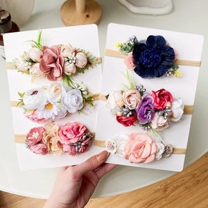 Detail of baby nylon headbands set with colorful simulation fabric flowers for photography