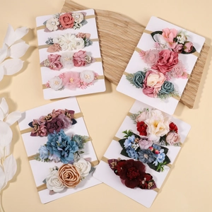 Close-up of handmade floral nylon baby headbands with chiffon flowers and pearls
