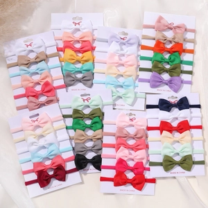 Close-up of colorful ribbon bow baby headbands with soft elastic nylon straps for infants