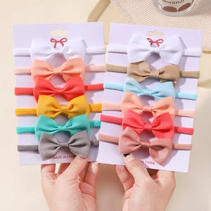 Set of 6 textured ribbed bow headbands for babies in assorted colors on card display