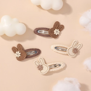 Detail of 4-piece bunny embroidery hair clips set with floral accents for girls