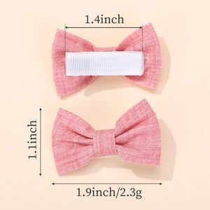 Pink checkered and polka dot bow hair clips for girls featuring size and weight details
